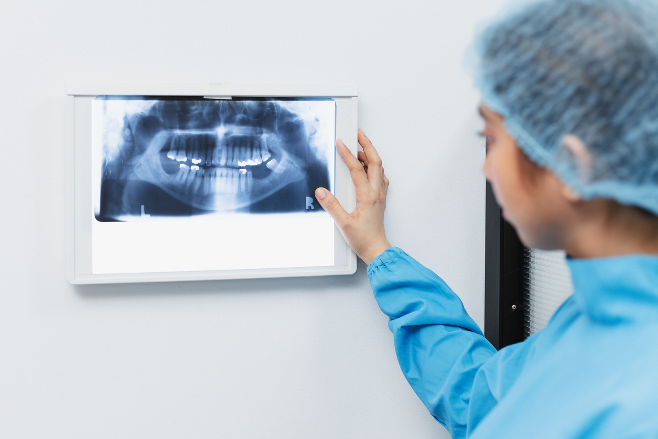 Female Dentist Examining Dental X-ray